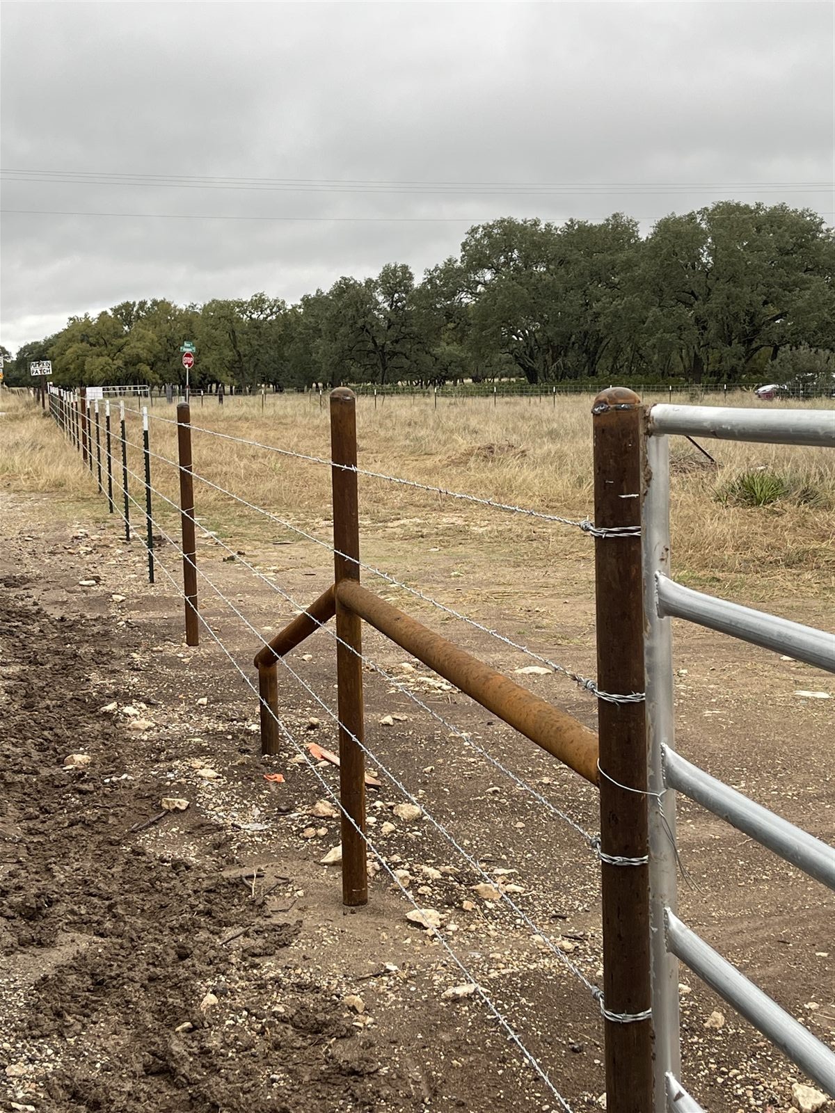 Barbed wire ranch fence with cedar posts