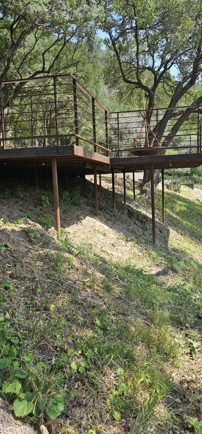 Steel elevated deck with pipe handrails